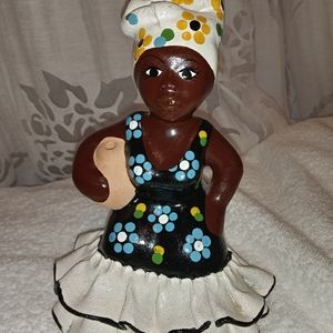 Hand painted  woman wearing traditional clothing, carrying a water jug figurine.